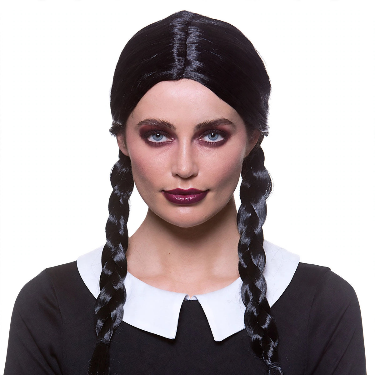 Close-up view of black plaits on womens Halloween school girl wig